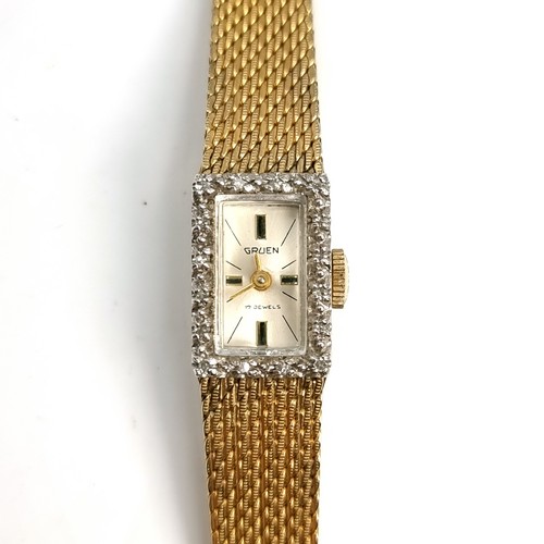 24 - A Gruen 17 jewelled ladies wrist watch with gem set bezel with patterned hands. Strap 10 carat fille... 