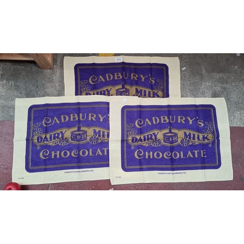 413 - Set of three vintage Cadbury's Dairy Milk Chocolate tea towels. The design is based on the 1915 wrap... 