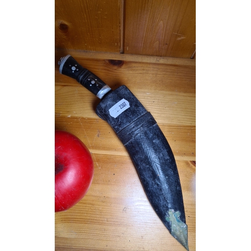 467 - Traditional Kukri Knife. Features a curved blade and a handle with decorative inlays. Comes with a b... 