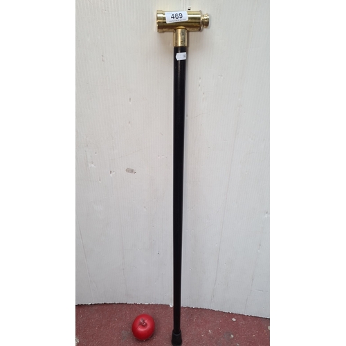 469 - A fantastic black walking cane with a working brass telescope handle.