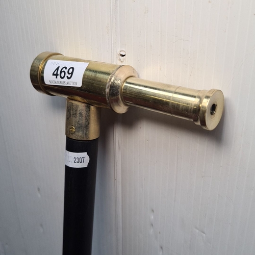 469 - A fantastic black walking cane with a working brass telescope handle.