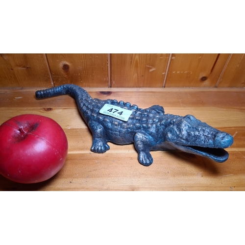 474 - A heavy cast iron crocodile figure with a realistic textured finish.