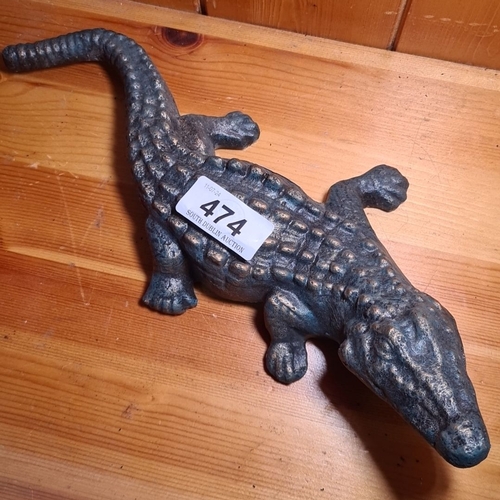 474 - A heavy cast iron crocodile figure with a realistic textured finish.