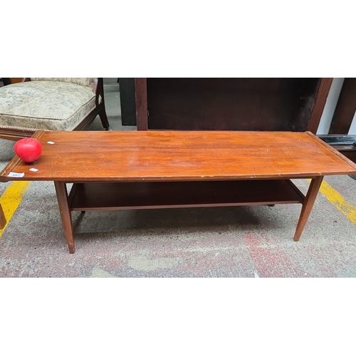 482 - A stunning Mid-Century Modern teak coffee table with under-shelf storage, circa 1960s.