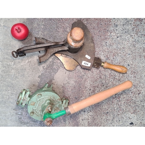 484 - Two charming vintage hand tools. Including a Victorian cast iron tool equipped with a thick blade, o... 