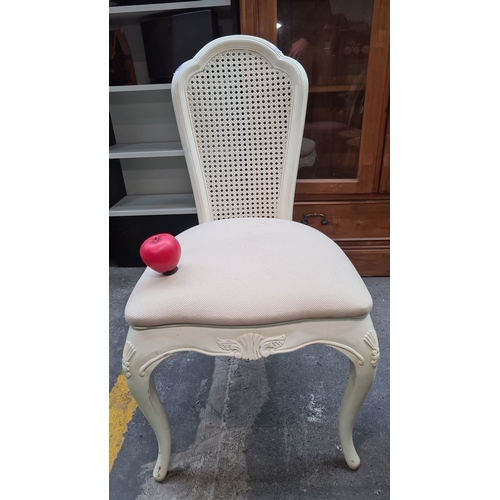 488 - A gorgeous French style carved wood chair with an upholstered seat and a woven cane backrest, painte... 