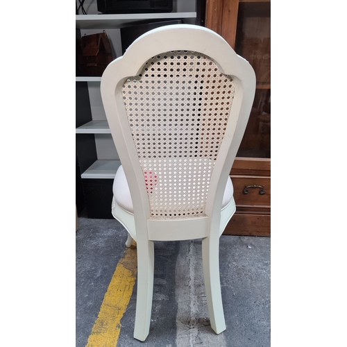 488 - A gorgeous French style carved wood chair with an upholstered seat and a woven cane backrest, painte... 