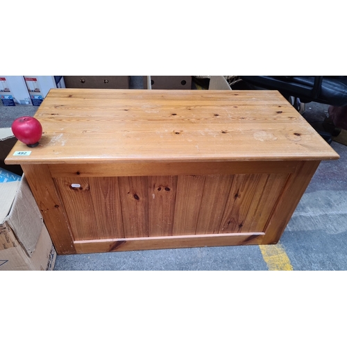 492 - A solid pine wooden storage chest with hinged lid. Spacious interior with dimensions approximately 4... 