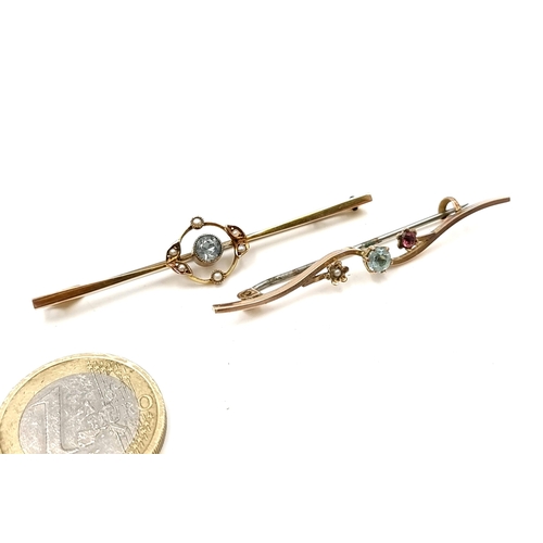 16 - Two gold antique brooches, each featuring designs which includes Aquamarine, Seed Pearls and Rubies.... 