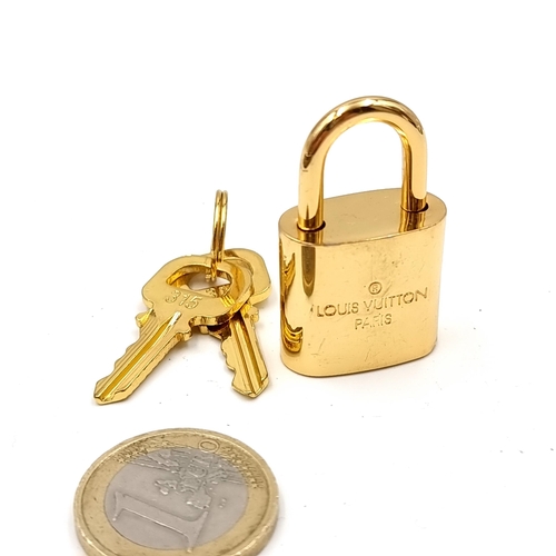 20 - An original designer Louis Vuitton gold metal padlock with two keys marked Louis Vuitton, Paris . We... 