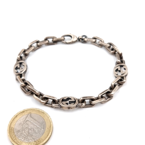 24 - Star Lot : An original designer Gucci sterling silver chain link bracelet set with lobster clasps. W... 