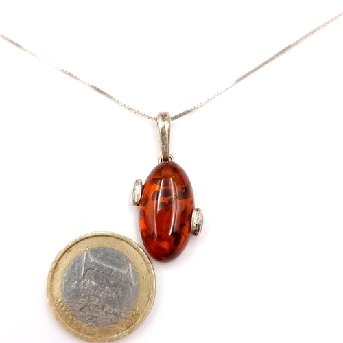 39 - A Baltic amber sterling silver mounted pendant with sterling silver chain. Length - 50 cms. Weight -... 