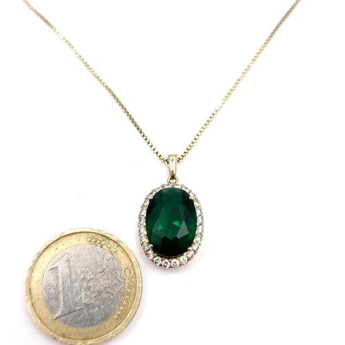 48 - A pretty tourmaline oval pendant with Zirconia surround with silver gilt box chain. Length - 46 cms.... 