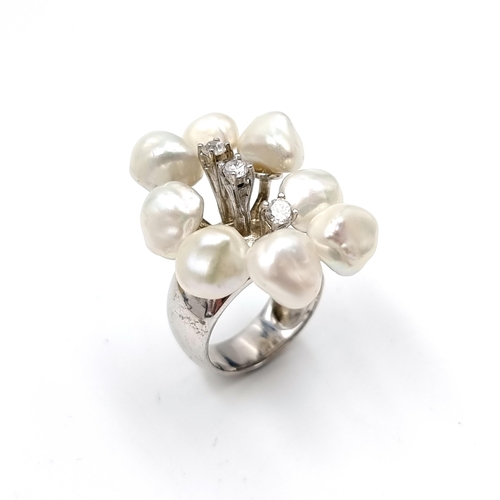 53 - A very unusual eight cultured pearl ring with three gem set accents. Ring size - N. Weight - 11.6 gr... 