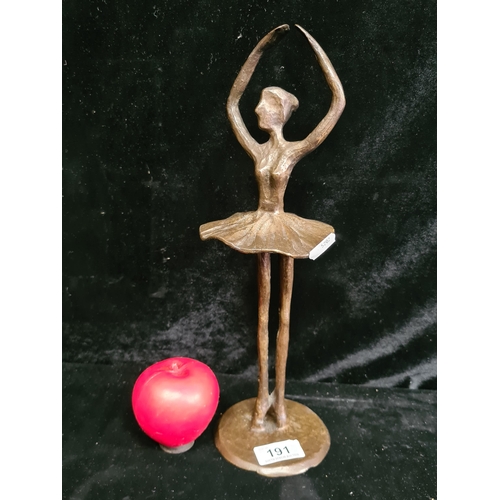 A tall heavy bronze figure of an elegant ballerina.