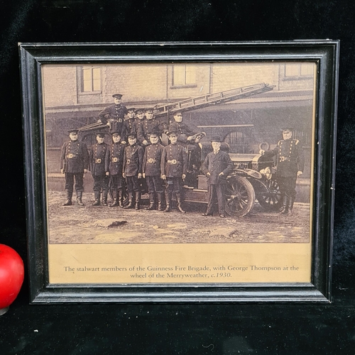 79 - A vintage print of a 1930's photograph featuring the Guinness Fire Brigade. Housed in a black wooden... 