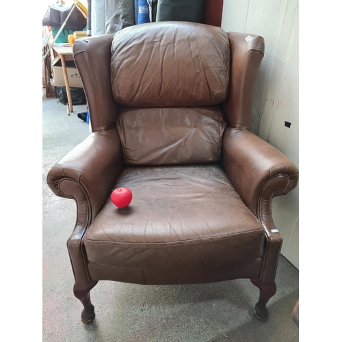 387 - A comfortable wing backed armchair in brown leather. Looks comfy. From a very fine home in Templemor... 