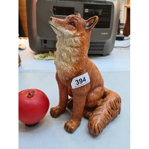 394 - A charming heavy cast figure in the form of a fox.