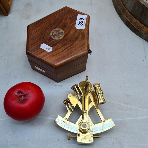 399 - A brass lifeboat sextant housed in a wooden case. A nautical instrument.