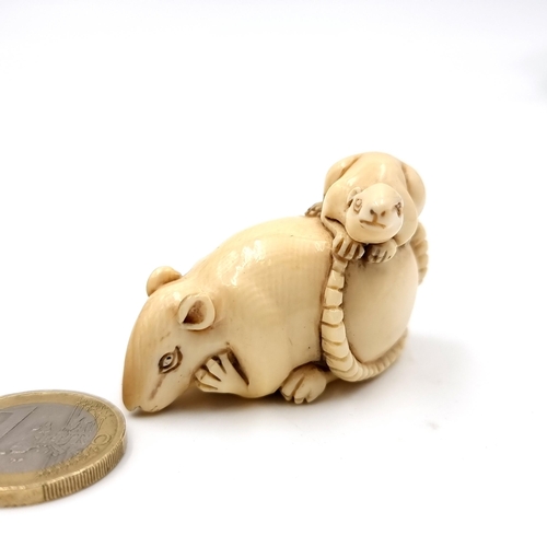 501 - A most attractive original Japanese carved antique bone Netsuke (two holes) in the form of a mother ... 