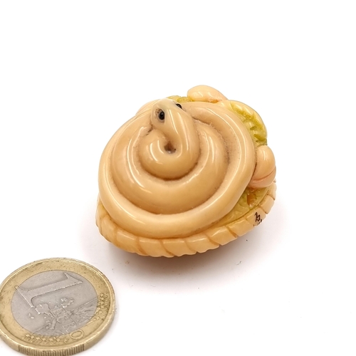 505 - A fantastic original antique bone carved Netsuke (two holes) in the form of a mounted snake lying on... 