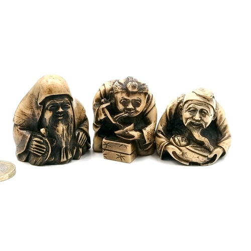 521 - A collection of two carved Netsuke figures (two holes) depicting two seted gentlemen. Also a further... 