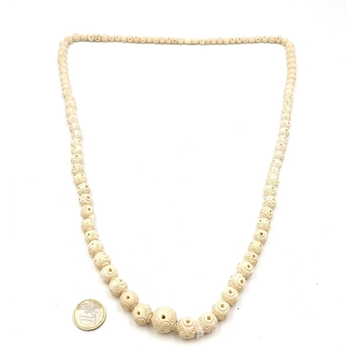 522 - An excellent example of an antique hand carved  bone  graduated necklace with twist clasps. Length o... 