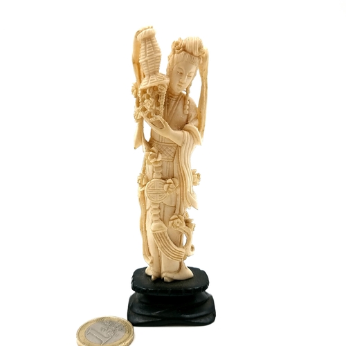 525 - A late 19th/early 20th century antique Japanese carved bone figure of Guanyin standing on a carved p... 