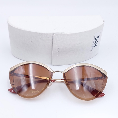 548 - A pair of as new Prada sunglasses made in Italy with reference details to stems. Comes with original... 