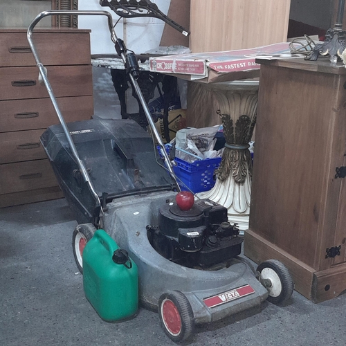 1008 - A Victa Briggs & Stratton petrol lawn mower with twin grip safety catcher and additional petrol cann... 