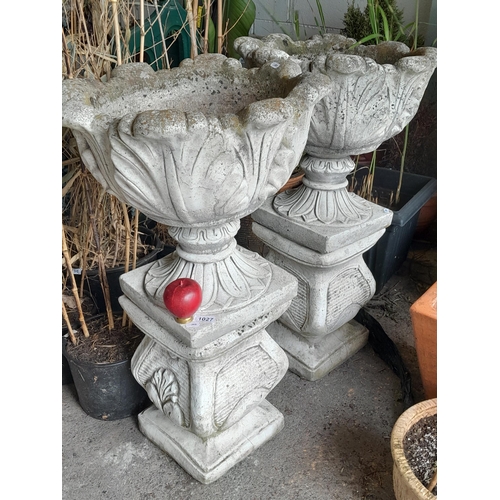 1027 - Star Lot: A large pair of two piece pedestal acanthus leaf urns. MM: 84cm tall 48cm wide.