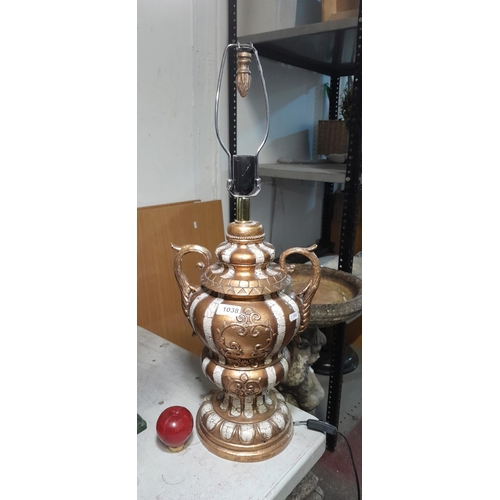 1038 - A very large gold table lamp with acanthus leaf handles and bayonetted bulb fixture.