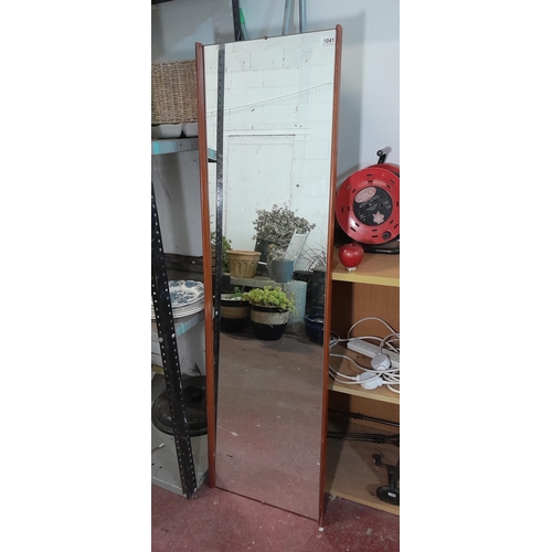 1041 - A long horizontal wall mirror with wooden edges and mounting hooks to verso. MM: 147cm x 43cm.