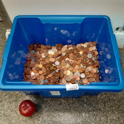 1052 - A large blue container comprising about 20-30 kg of mixed, unchecked coinage.