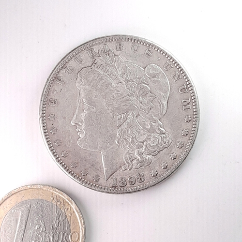 1065 - An 1898 United States of America Morgan silver one dollar coin. In very good condition, lots of deta... 