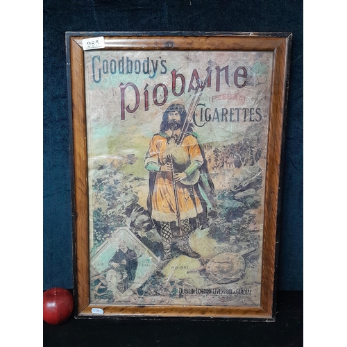 985 - An advertising poster featuring 'Good body’s Piobaine Cigarettes'. Housed in a wooden frame behind g... 