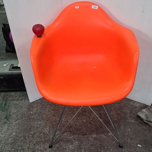 744 - A new Mid-Century Modern style orange molded plastic armchair with metal Eiffel base.