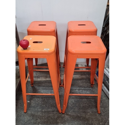 750 - Set of four industrial sturdy metal bar stools with a bright orange finish, featuring a stackable de... 