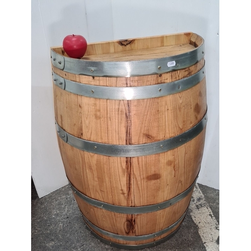 751 - An as new decorative Wooden half-barrel with metal bands.