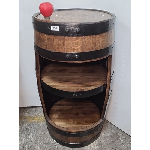 754 - Star Lot : A large Rustic wooden barrel with a wooden top and enhanced with black metal bands. It is... 