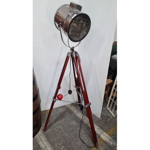 756 - Light Tripod Search Light, model 66024. Made with a polished metal head and adjustable wooden tripod... 