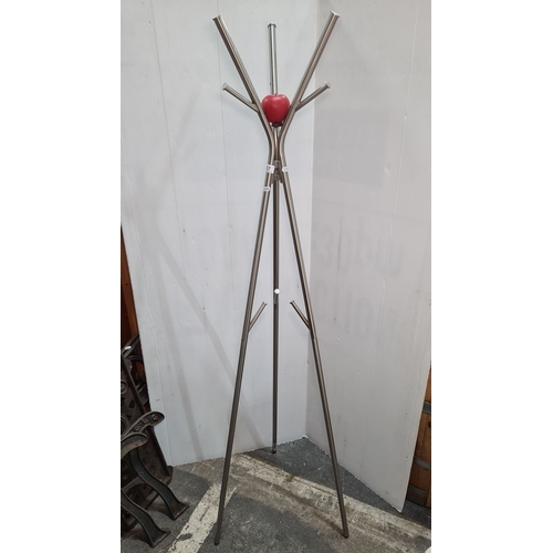 757 - Metal coat rack with a contemporary design. Features a central red accent and multiple hooks. Made f... 