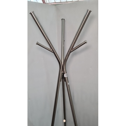 757 - Metal coat rack with a contemporary design. Features a central red accent and multiple hooks. Made f... 