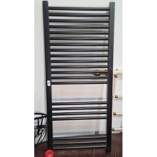 762 - Black metal ladder-style radiator with horizontal bars. This radiator is designed for wall mounting ... 