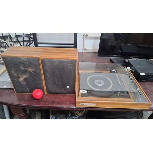 765 - Vintage Fiesta Matador III turntable with speakers. Features a wood casing and a plastic dust cover.