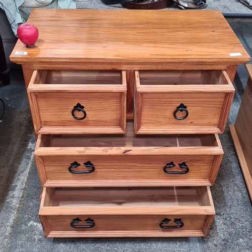 778 - Pinewood four-drawer chest with black metal handles. The chest has a rectangular top and a natural w... 