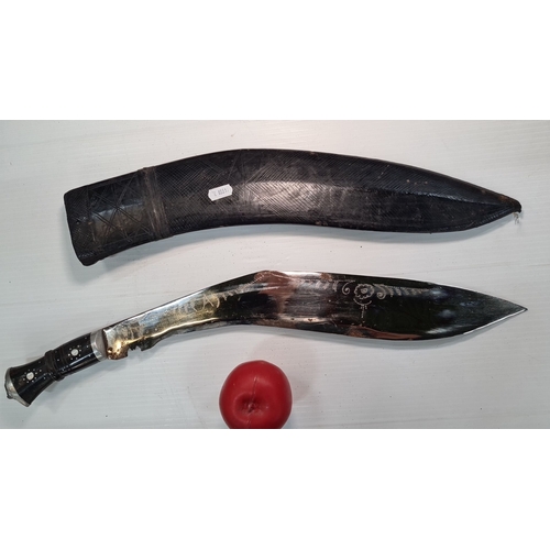 793 - Traditional originalNepalese Kukri knife with ornate patterns on the blade, black handle, and black ... 