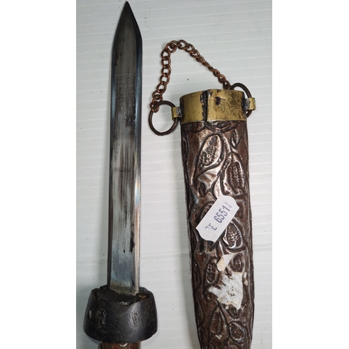 795 - Antique dagger with an ornate engraving on its metal scabbard, featuring leaf patterns and a brass c... 