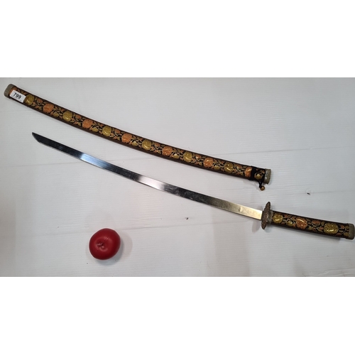 799 - A decorative katana with floral-embroidered scabbard and handle. Elaborately etched blade showcasing... 