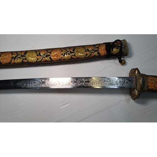 799 - A decorative katana with floral-embroidered scabbard and handle. Elaborately etched blade showcasing... 